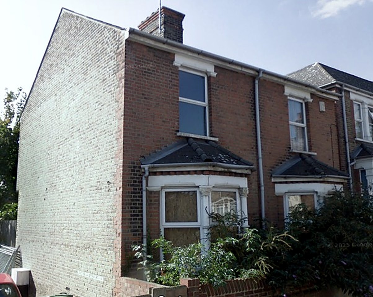 An end of terrace house with boarded up bay windows, the children’s home Louis was placed in at fifteen